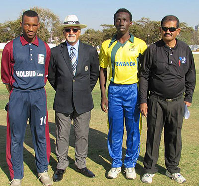 Rwandau2019s U19 captain Don de Dieu Mugisha poses with match umpires before the game against Swaziland on Sunday. Courtesy photo