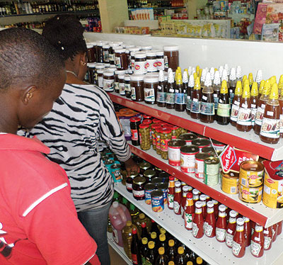 Shoppers check prices of items in a city supermarket. It is important for businesses to indicate prices clearly. File.