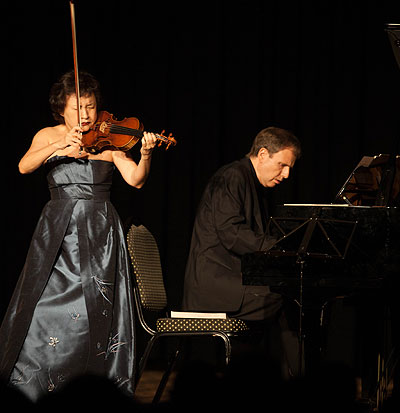 Above, Kyung-Wha Chung and pianist Kevin Kenner perform at Kigali Serena Hotel  and right, the Korean artiste puts her soul into her music . Photos by T. Kisambira