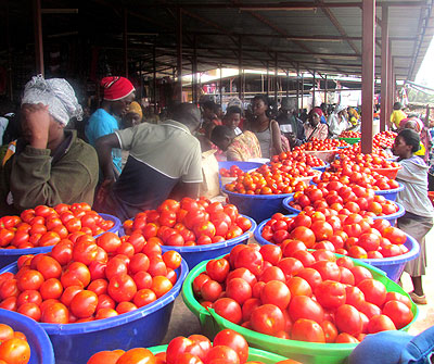 Murekatete (standing, right) in Ngoma market. The trader earns about Rwf3 million in sales a year. (Stephen Rwembeho)