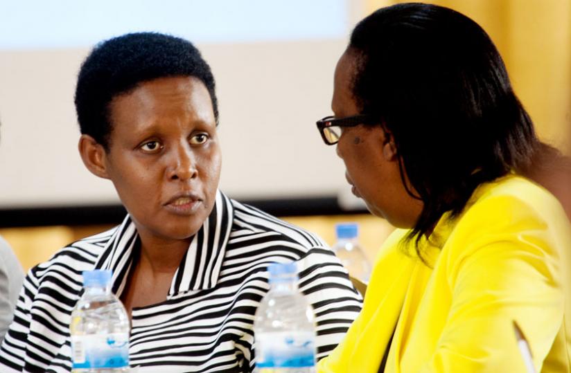 Chief Gender Monitor Rose Rwabuhihi (R), chats with the Minister for Gender and Family Promotion, Oda Gasinzigwa, during the Gender Violence-Based Diologue in Kigali yesterday. Participants at the dialogue concurred that the issue of handling evidence remains a stumbling block in the prosecution of GBV cases. (Timohty Kisambira)