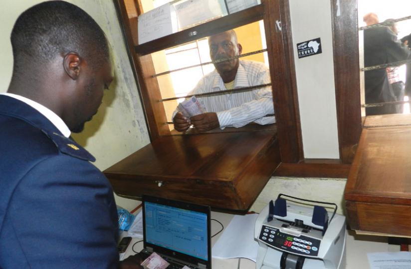 A trader pays taxes at Rusumo border. EAC business leaders want governments to harmonise transfer pricing laws.