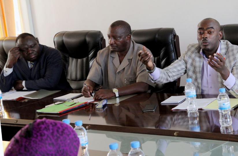 Mbidde (right) stresses a point as Frederic Ngenzebuhoro (centre) and Christophe Bazivamo look on at the meeting yesterday. (John Mbanda)