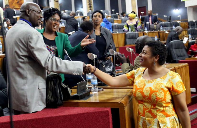 Abdul Karim Harelimana (L) greets Shy-Rose Bhanji as Judy Pareno looks on after the house was adjourned yesterday. (John Mbanda)