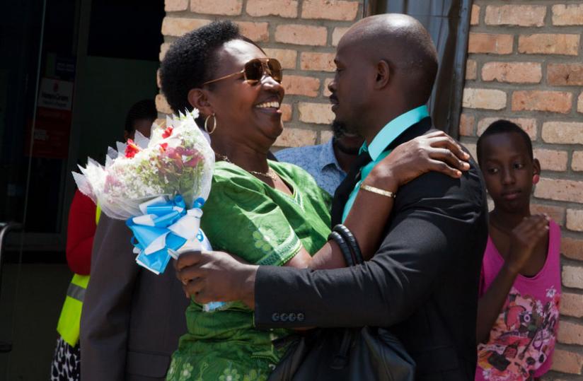 Frankie Joe is hugged by his mother at Kigali International Airport. (Doreen Umutesi)