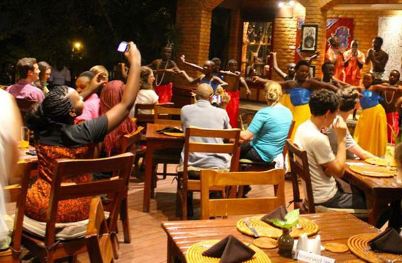 Guests enjoy a traditional dance performance during the art exhibition at Heaven Restaurant.  