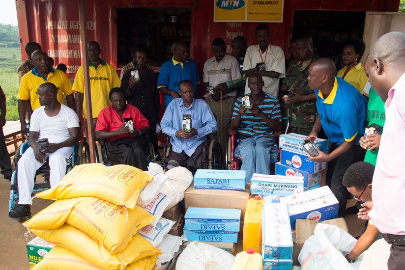 Disabled veterans in Rugende receive an assortment of items on Monday. rn(Timothy Kisambira)