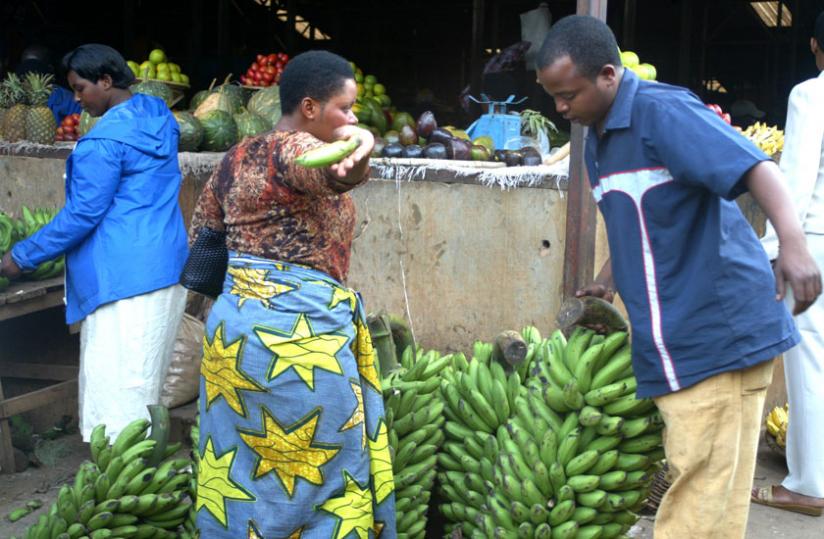 A man buys a bunch of bananas from Kimironko market. (File)