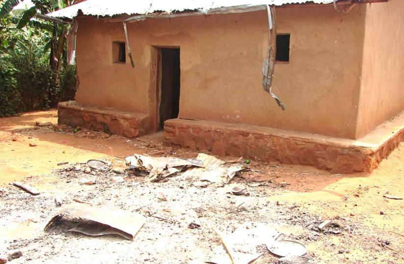 The house that was destroyed by an angry mob after the owners were suspected of practising witchcraft in Shonga Village, Tabagwe Sector in Nyagatare District last week. Foreground, ash from suspected juju. (Stephen Rwembeho)