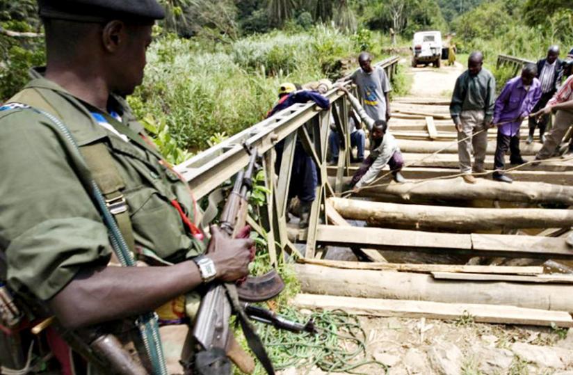 An FDLR militiaman guards a bridge at Village Petit in Eastern DR Congo. (Net photo)