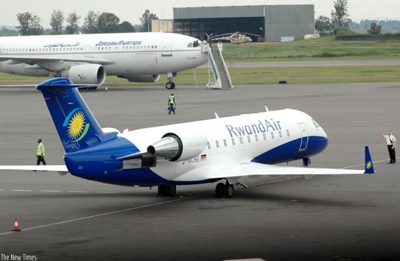 RCAA staff directs a RwandAir plane at Kigali International Airport. (File)