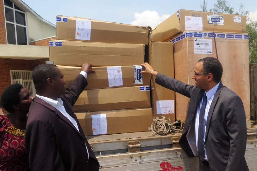 Emmanuel Mazimpaka (left), the vice mayor for economic affairs and Alemu observe some of the equipment in Ngororero District on Thursday. (Thu00e9ogu00e8ne Nsengimana)