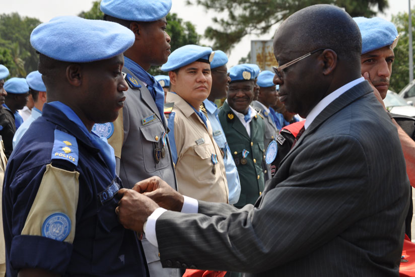 Inspector of Police, Olivier Habimana, RNP officer serving in UNOCI, being decorated by Simon Munzu, the United Nations Secretary-General's Deputy Special Representative for Cote d'Ivoire. (Courtesy)