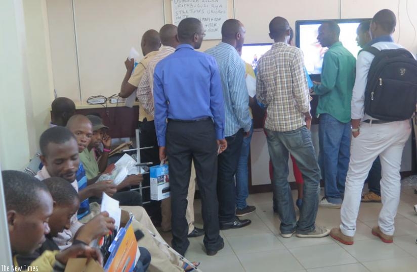 Customers line up to pay subscription charges or buy top set boxes at StarTimes head offices in Kimihurira, Kigali. The pay-TV firm plans to raise monthly subscription fees next month. (Dennis Agaba)