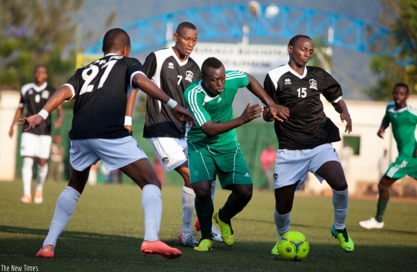 SC Kiyovu striker Julius Bakkabulindi (C) is sandwiched by three APR players during last year's Peace Cup quarter-final game. (T. Kisambira)