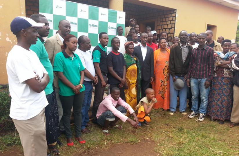 Some of the beneficiaries pose for a photo with Hima Cement Rwanda employees. (Geoffrey Wakibi)