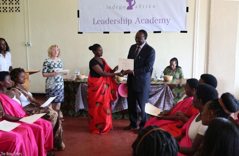 Trade and Industry minister Kanimba (R) awards certificates to the graduates yesterday. (John Mbanda)