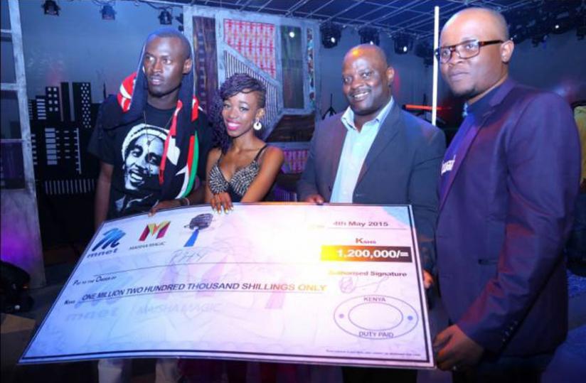 Phy Ng'etich (lady) holds the dummy cheque after winning Maisha Superstar . Net. (File)