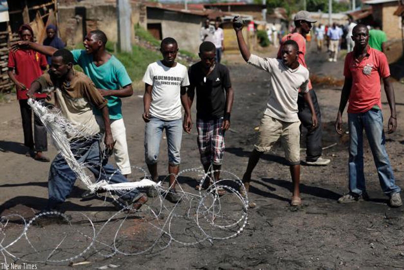 Demonstrators shout at army and police officers in the Musaga district of Bujumbura, yesterday.