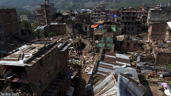 Local residents walk past collapsed houses after the April 25 earthquake in Sankhu on the outskirts of Kathmandu, Nepal, May 11, 2015