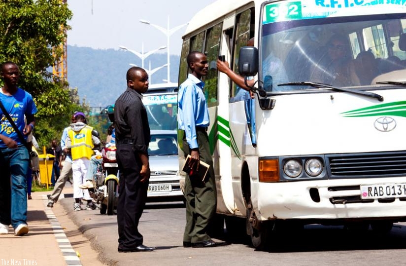 Passengers board an omnibus at Kimihurura bus station. (Timothy Kisambira)