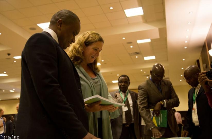 State Minister for Primary and Secondary Education Olivier Rwamukwaya (L), Noala Skinner, UNICEF country representative (2nd left), and other guests read through the   new curricullum during its launch on April 23, in Kigali. (Timothy Kisambira)