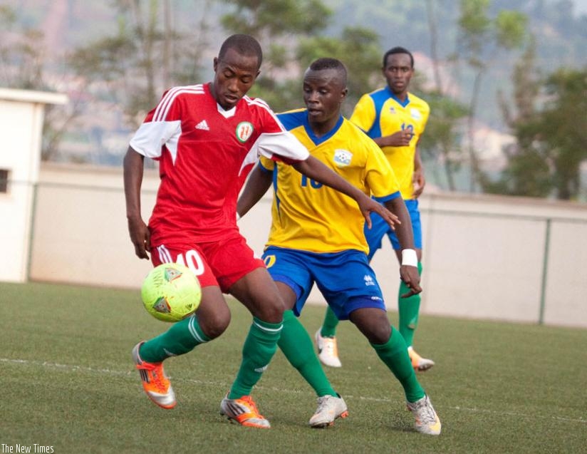 Robert Ndatimana (R) of Amavubi struggles for the ball against a Burundian player during a friendly game at Kigali Regional stadium last year. The stadium is amongst the  facilities that will host the tournament. (File)