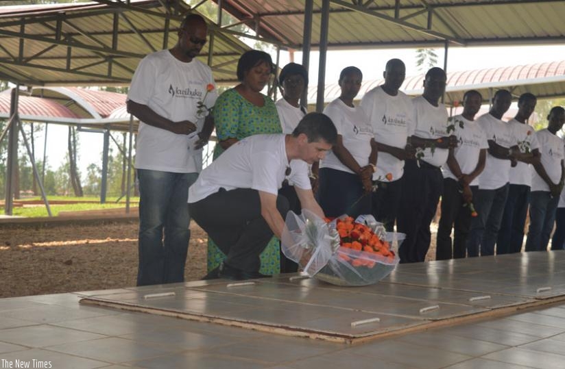 Ballore-Africa Logistics staff lay a wreath  on a grave at Nyanza Genocide Memorial site . (G. Wakibi)