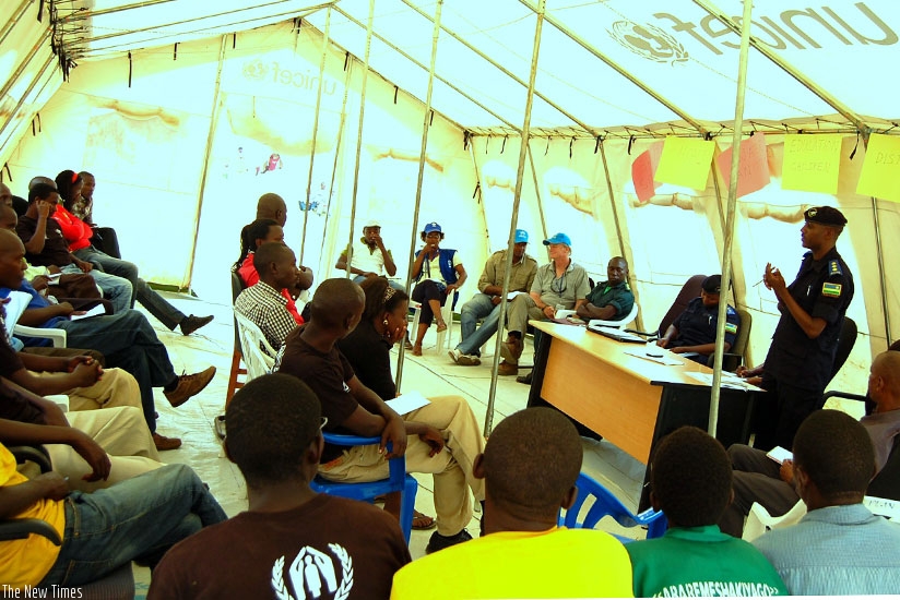 Police officers addressing some refugees in Mahama camp in Kirehe District