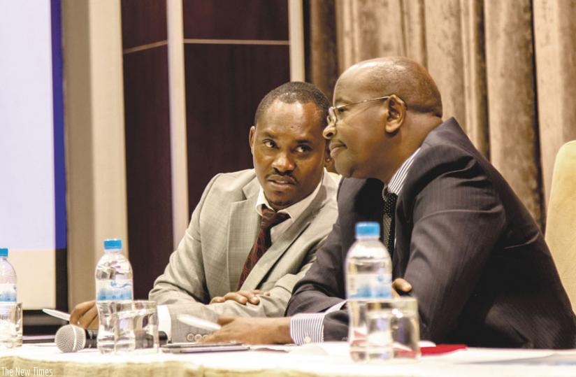 Sano (L) consults with Minister Musoni during the media briefing in Kigali yesterday. (Timothy Kisambira)