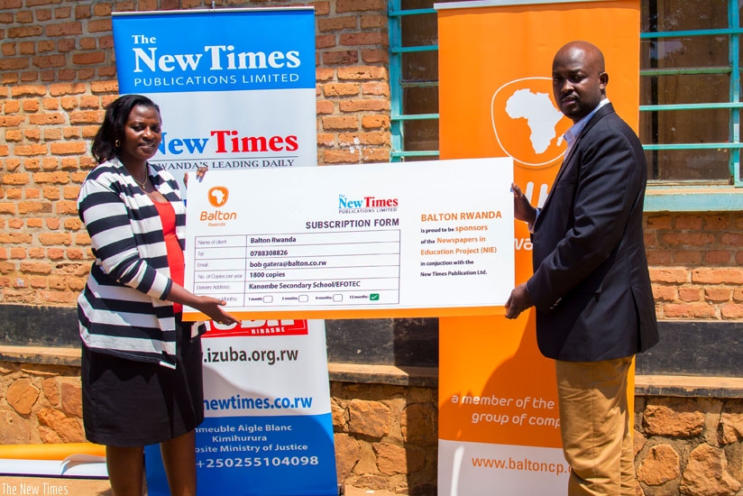 Balton managing director Bob Gatera (R) and Monica Leonard Tumukunde, the Efotec headteacher, present the agreement after the signing ceremony at the school yesterday. (All photos by Doreen Umutesi)