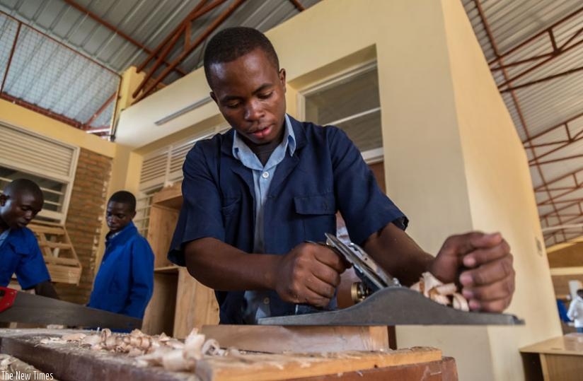 A student at VTC Muganzi in Rusizi district makes a chair during a practical lesson. (Timothy Kisambira)