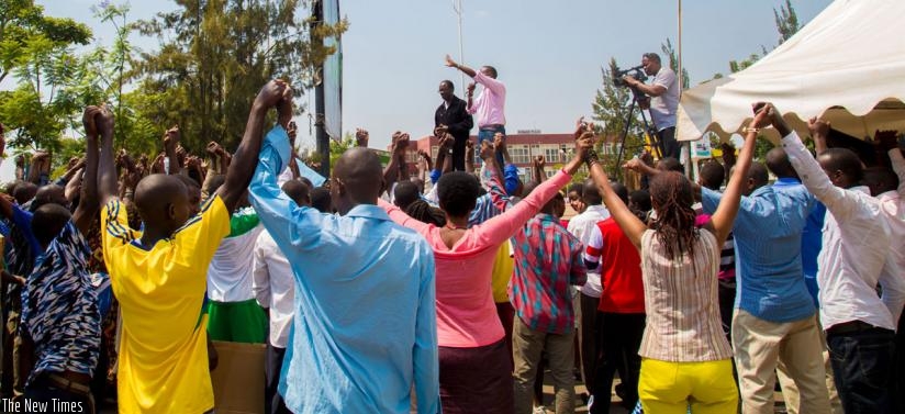 Protesters join hands to show solidarity on the last day of demonstrations against the arrest of Gen Karenzi Karake at the British High commission in Kigali a week ago. (D. Umutesi)