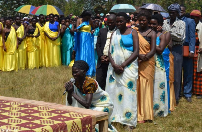 An elderly woman in Musanze kneels down as she requests the Members of Parliament to amend the Constitution to allow the President another term in office. (Jean d'Amour Mbonyinshuti)