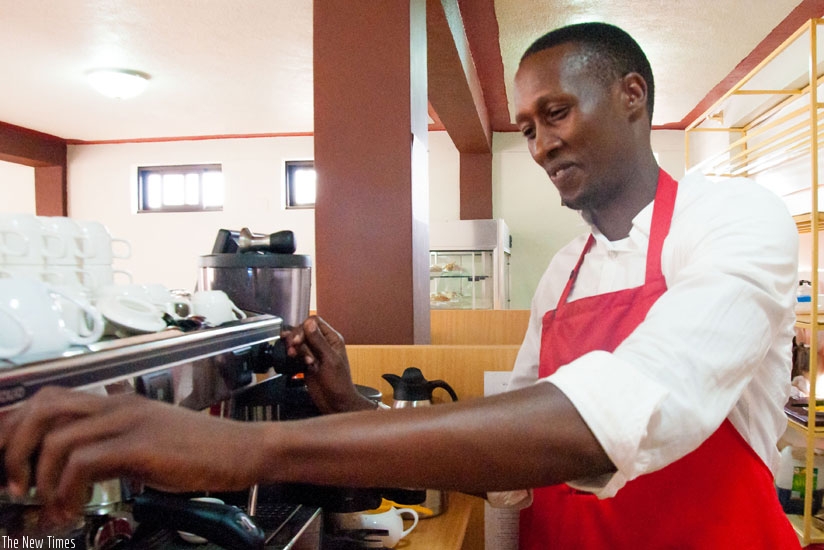 Mutimura preparing coffee. His main goal now is to open his own coffee shop soon.  (Teddy Kamanzi)