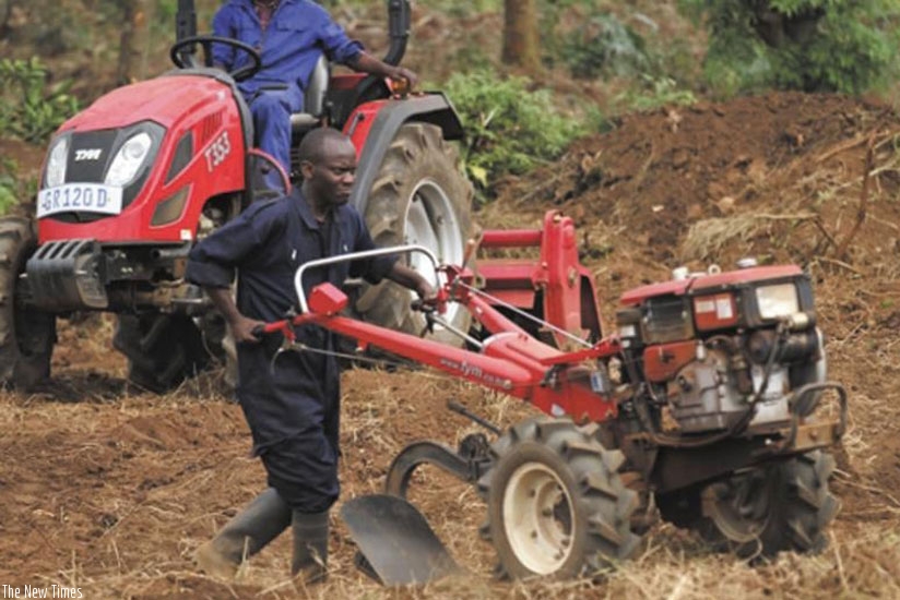 A farmer uses a hand-held plough to cultivate. Government is working with private partners to realise Agriculture mechanisation. (File)