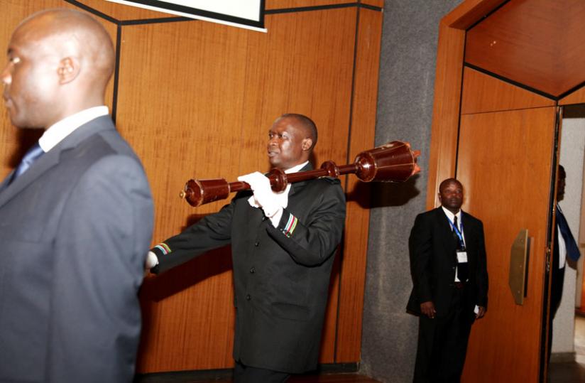 The Surgent at Arms carries a mace into Parlaiment to begin a session in Kigali last year. (File)