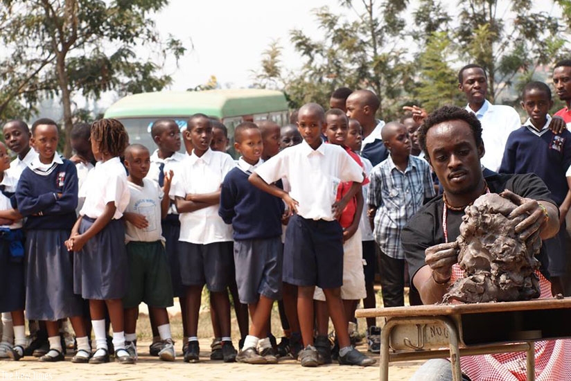 The artist shares his skills with young school children.