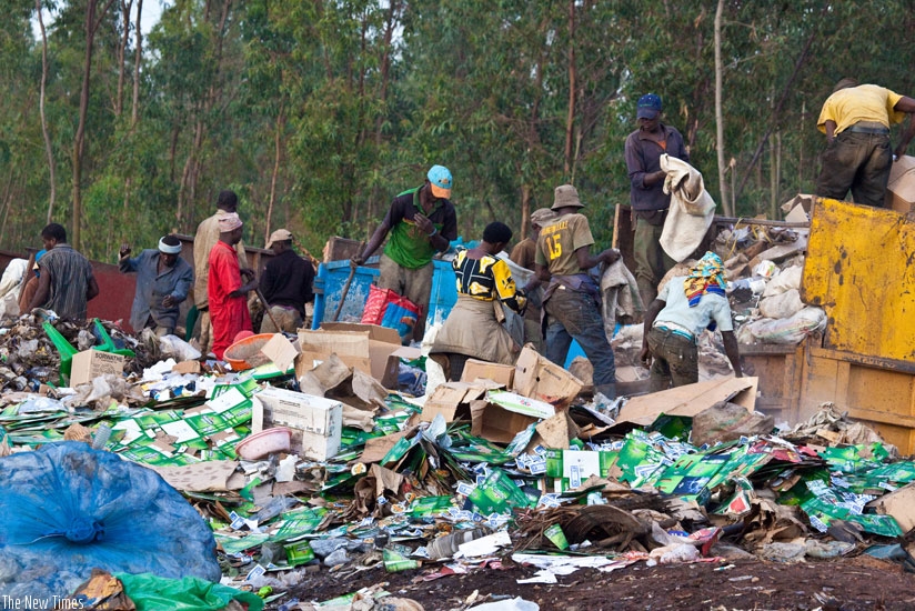 Workers  sort gabbage at Nduba dump site in Gasabo District. (Timothy Kisambira)