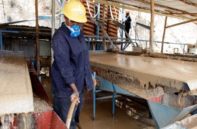 A worker at Mutobwe mining factory separates minerals from water. File)