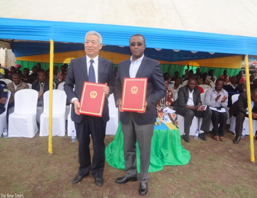 Amb. Shen and Minister Biruta show documents for the constructed boreholes on Monday. (Jean Fidele Ndungutse)