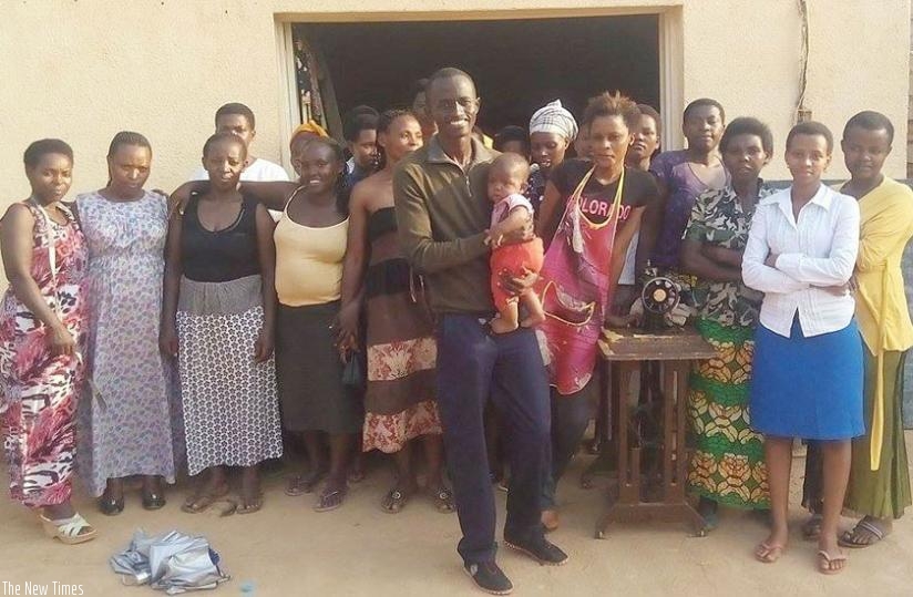 Bertrand Ishimwe (holding a child) with some of the women they help. (All photos by Joseph Oindo)