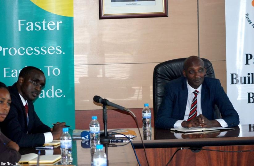 RRA's boss Tusabe (R) and TransUnion's Nkuranga at the signing of the agreement ceremony in Kigali  yesterday. (Peterson Tumwebaze)