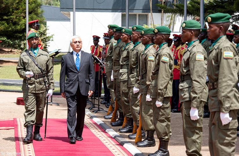 Amb. Kiyokazi inspects a guard of honour at Village Urugwiro in Kigali yesterday. (Courtesy)