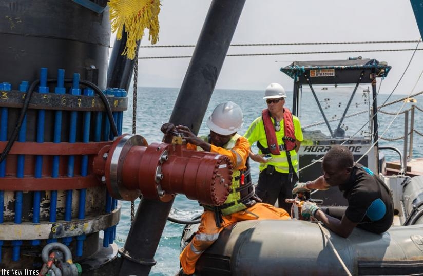 Workers fix equipment at KivuWatt project. (File)