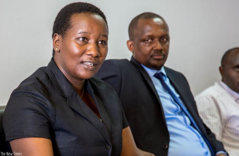 Uwacu explains to MPs the draft law that seeks to give districts the right to relocate some Genocide memorial sites as Louis Ndahigwa, CNLG's principal legal advisor, looks on yesterday. (Doreen Umutesi)