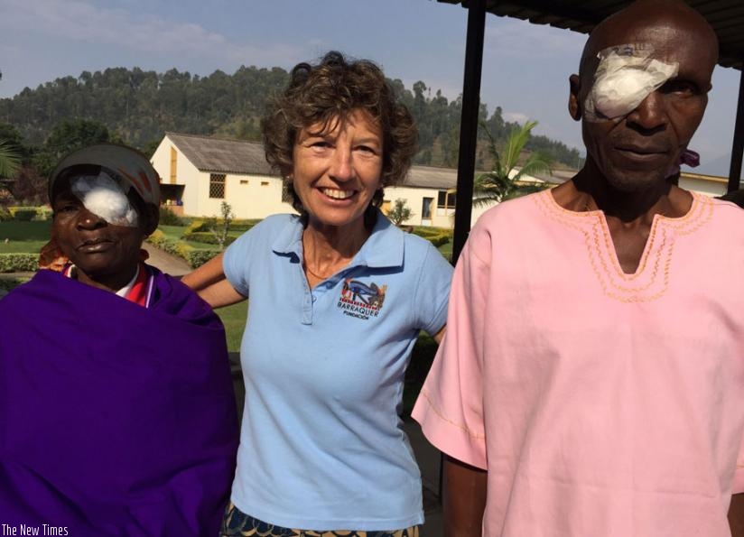 Dr Barraquer poses for a photo with patients who under went cataract surgeries at Ruhengeri Hospital. (J.F. Ndungutse)