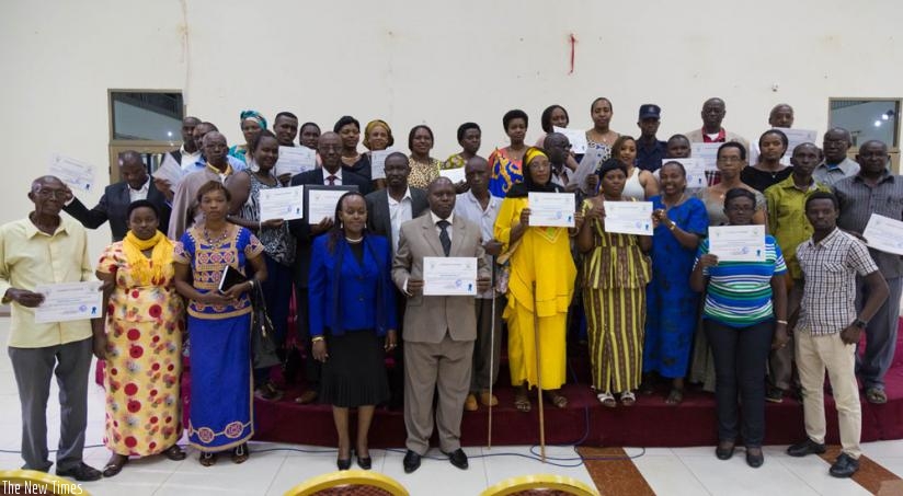 Members of community mediators (Abunzi) commitees pose for a group photo in Kimironko. (T.Kisambira)