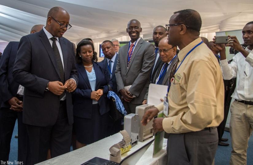 Daniel Gizaw, the chief executive of Ventus Technologies (R), showcases Smart Electric Meters to Minister Musoni (L) and Germaine Kamayirese, the minister of state for energy, water and sanitation (C), at the iPAD expo in Kigali yesterday. (Doreen Umutesi)