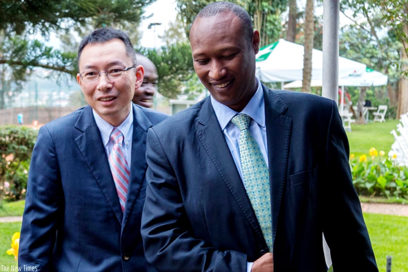 Takahiro Moriya, the chief representative of the Japan International Cooperation (JICA), chats with the Permanent Secretary at the Ministry of Infrastructure, Christian Rwakunda (R), during JICA's 10th Anniversary in Rwanda yesterday. (Timothy Kisambira)